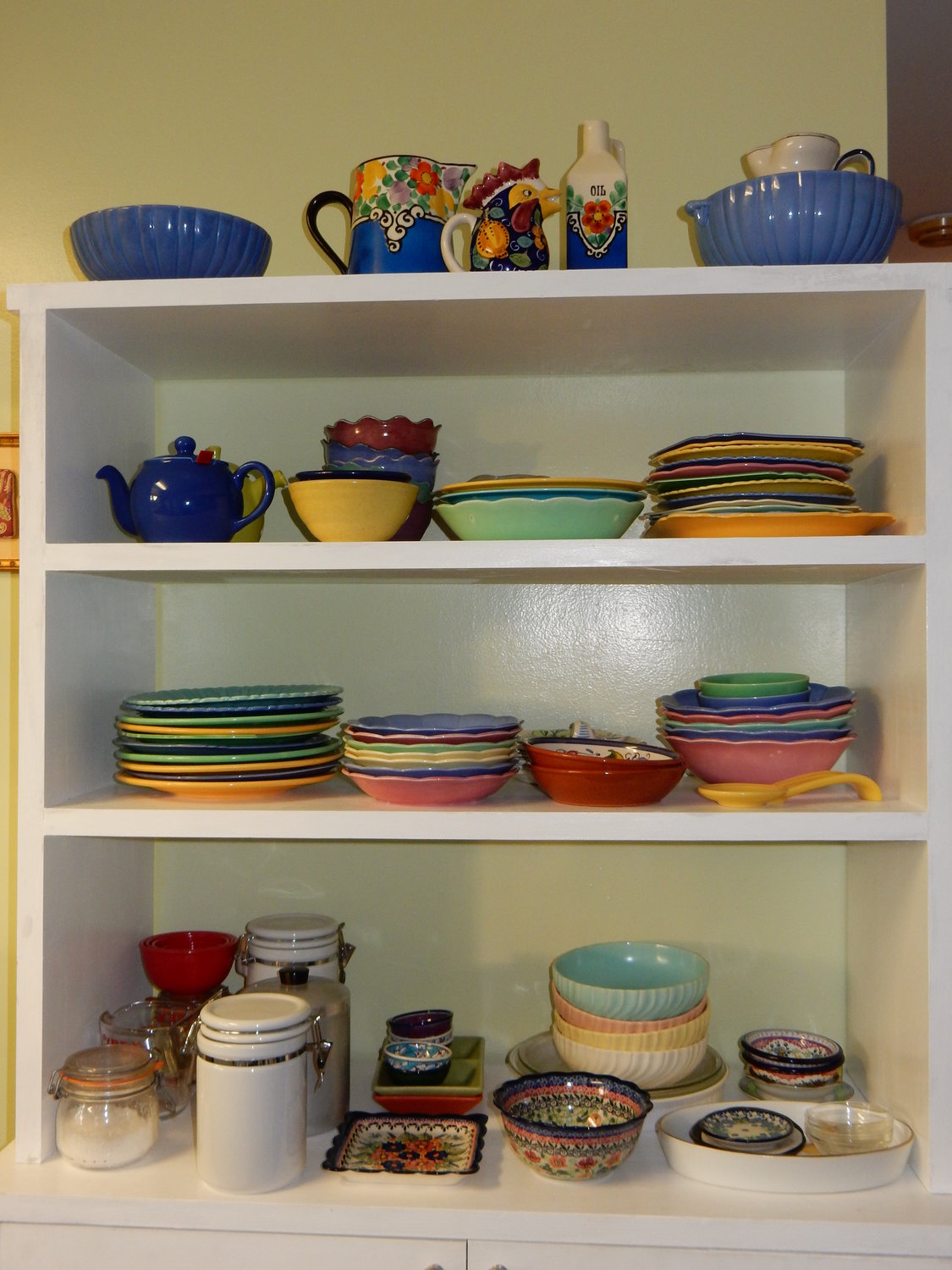 Dishes on shelves in kitchen.